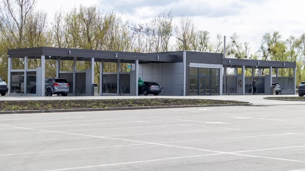 Self-service high-pressure car wash in the open air. Photo of an open self-service car wash. Manual car wash with pressurized water in a car wash outside