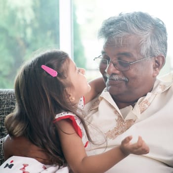 Portrait Indian family at home. Grandparent and grandchild close up face. Asian people living lifestyle. Grandfather and granddaughter.