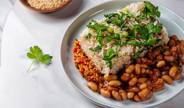 Pan-fried shrimp and blend of couscous, orzo, garbanzo beans, and red quinoa served with green peas and green onion close up on a plate on white background