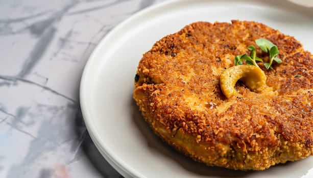 two chicken cutlets on a leaf of lettuce, mashed potatoes and tomato sauce. Kiev-style cutlets