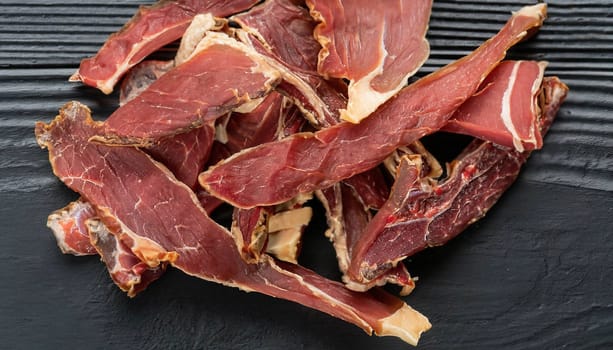 Raw pork sliced meat on wooden board on white background with dry basil leaves and spice. fresh raw beef lamb isolated on white. Heap of raw steaks