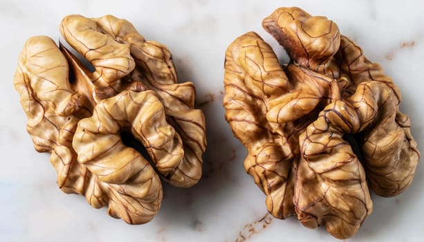 Full frame top view of heap of fresh raw brown crispy walnuts arranged on surface