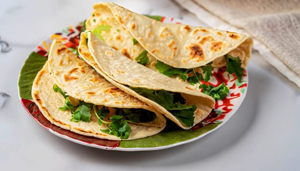 Fresh tortilla wrap with vegetables and salmon on plate