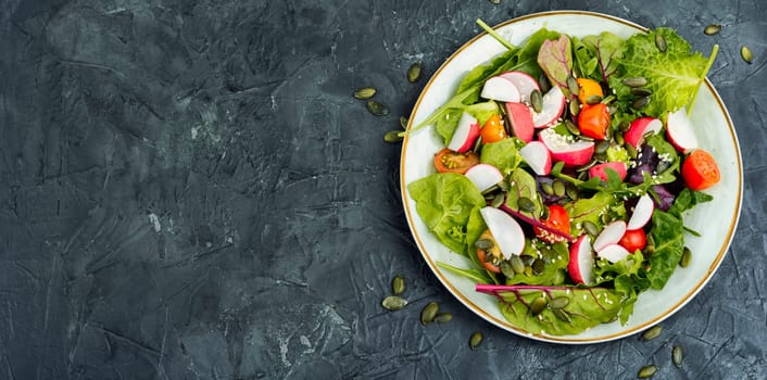 Easy salad with radish, greens, tomato and sesame seeds. Healthy diet food