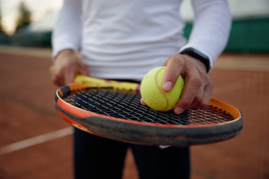 Close up of tennis player holding ball on racket for serving. Sports equipment for training workout and professional tournament match