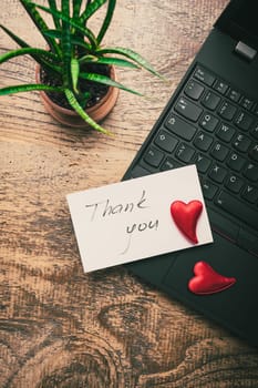 Thank you concept on the sticky note paper - notebook and plant