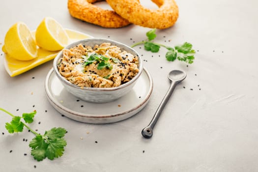 Vegan chickpea hummus spread with lemon and bagel