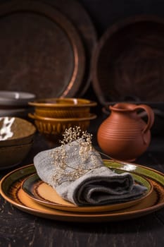 Set of kitchen ceramic and wooden tableware a table. Eco style home still life. Vintage style