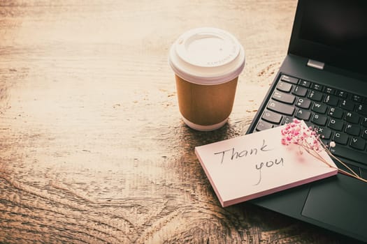 Thank you concept on the sticky note paper - notebook and coffee cup