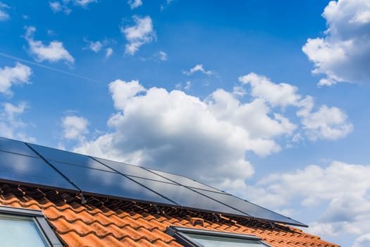 Photovoltaic panels on the roof of family house, solar panels. Environment and technology concepts.