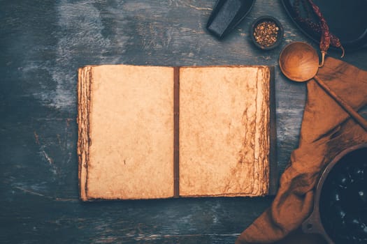 Empty menu or cookbook and kitchen utensils on wooden table, vintage style