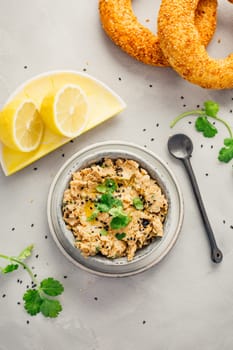 Vegan chickpea hummus spread with lemon and bagel
