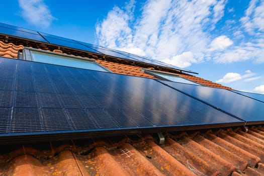 Photovoltaic panels on the roof of family house, solar panels. Environment and technology concepts.