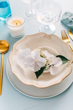 Spring shabby chic table setting, plate decorated with flowers
