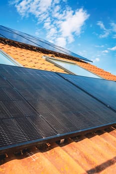 Photovoltaic panels on the roof of family house, solar panels. Environment and technology concepts.