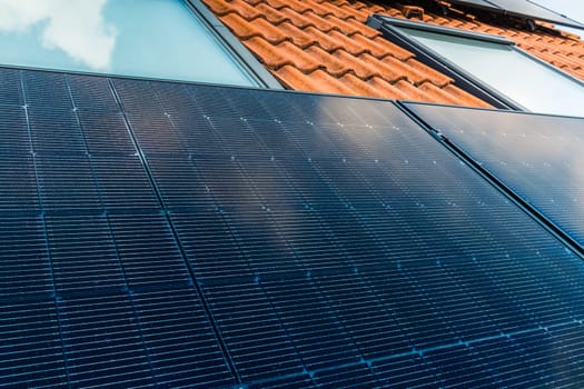 Photovoltaic panels on the roof of family house, solar panels. Environment and technology concepts.