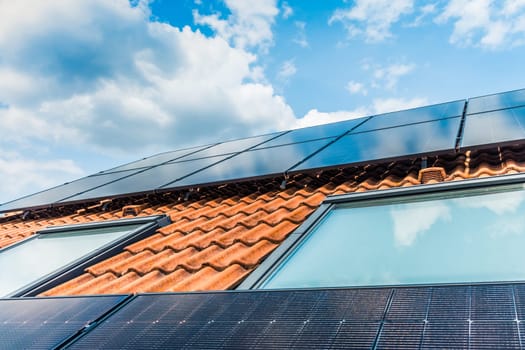 Photovoltaic panels on the roof of family house, solar panels. Environment and technology concepts.