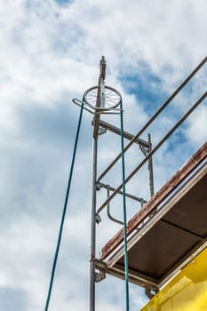 Using pulley for house renovation with scaffold pole platform. New build domestic building