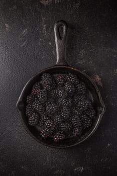 Organic blackberries in baking forms, ripe blackberries