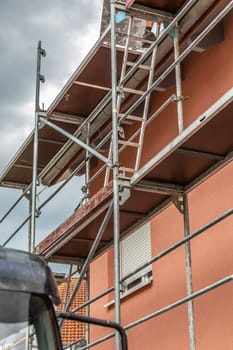 Modern house under construction with scaffold pole platform. New build domestic building