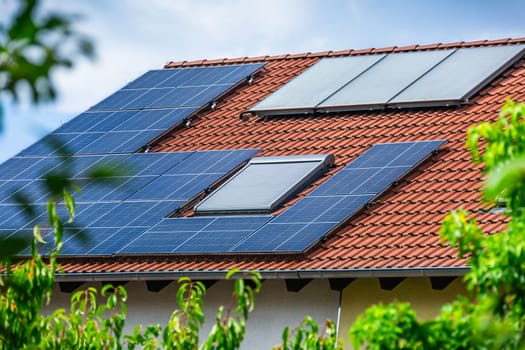 Photovoltaic panels on the roof of family house, solar panels. Environment and technology concepts.
