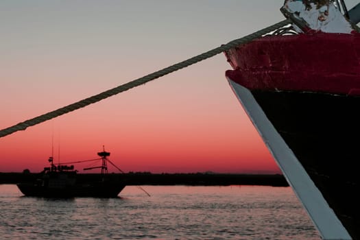 Anchored fishing ships at sunset. Fishing industry in andalusian coast, Spain