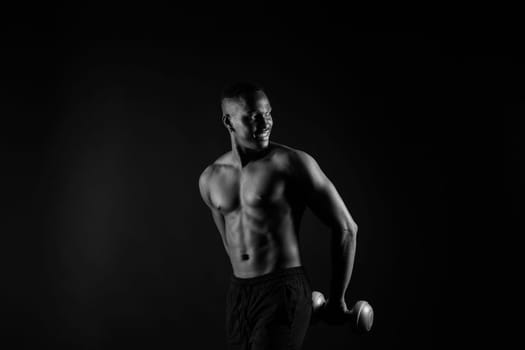 Portrait of athletic african american man topless smiling, yellow, red and black background