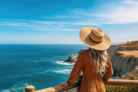 A woman in a hat stands on a cliff overlooking a blue ocean. Generative AI