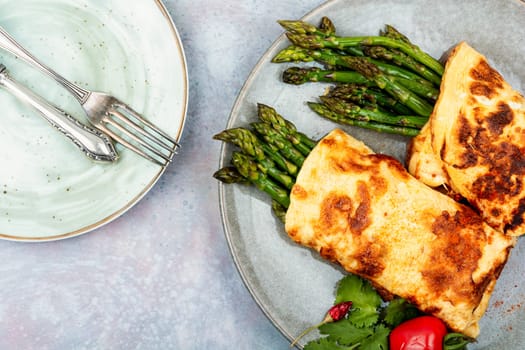 Freshly made omelette cooked with green asparagus for breakfast