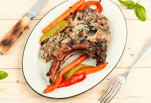 Roasted tomahawk pork meat steak on wooden table. rustic style. Top view