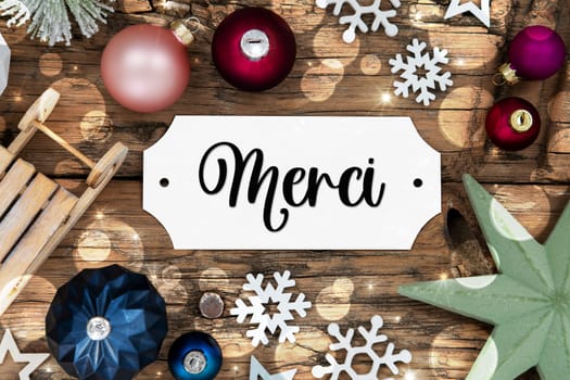 Colorful Christmas Decor With Bokeh, Christmas Balls And Snowflakes, With Sign With French Text Merci, Which Means Thanks In English