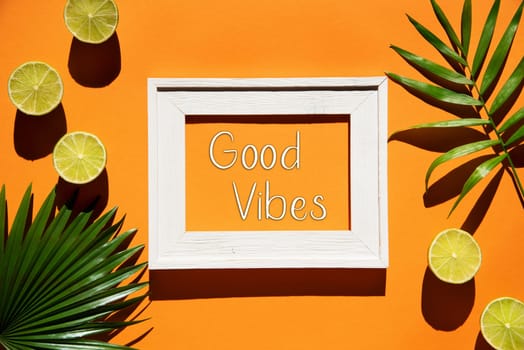 Flat Lay With English Text Good Vibes. Orange Background With Picture Frame And Tropical Lemon And Palm Leaf.
