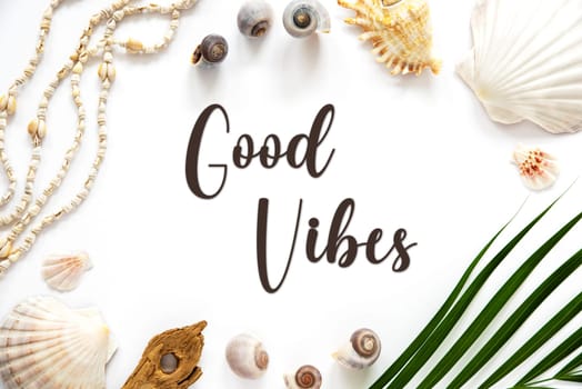 White Summer Flat Lay, Top View, Decorated With Shells and Plants, With English Text Good Vibes