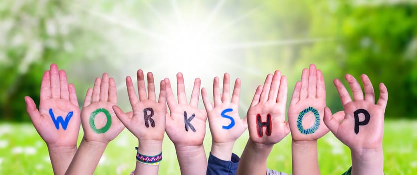 Children Hands Building Colorful English Word Workshop. Sunny Green Grass Meadow As Background.