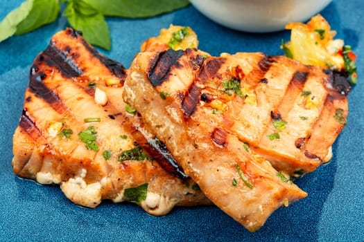 Grilled tuna steak with sauce on a plate. Seafood fried. Close up.