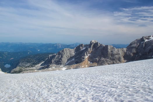 Panorama of massive Alpine mountains. Landscape in the Austrian Alps of the Dachstein region (Styria in Austria) - view from Dachstein