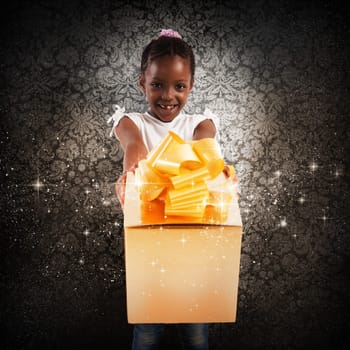 Happy little girl with a golden gift
