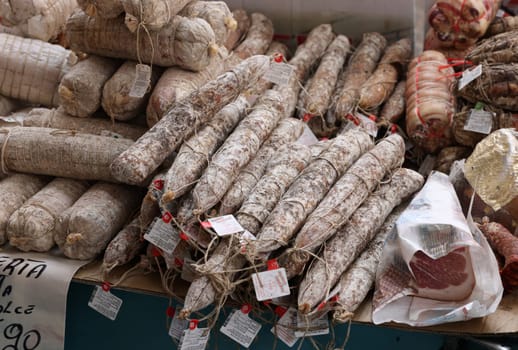 Cremona, Italy - September 7, 2022: Traditional meat products sold at a street stall during the farmers market in Cremona, Lombardy, Italy