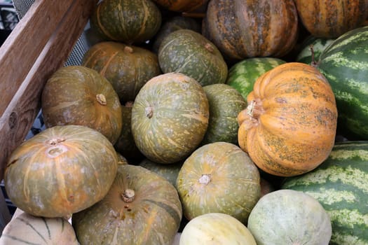 Ripe pumpkins and melons sold at a street stall during the farmers market in Cremona, Lombardy, Italy