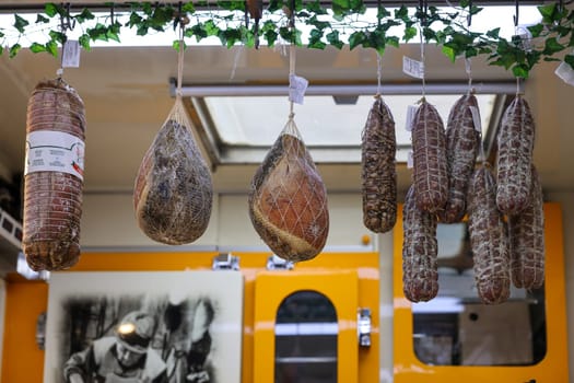 Cremona, Italy - September 7, 2022: Traditional meat products sold at a street stall during the farmers market in Cremona, Lombardy, Italy