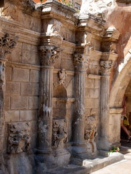 Rimondi Fountain in Old Town of Rethymnon in hot summer day. Crete, Greece.