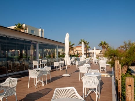 Rethymnon, Crete, Greece - June 15, 2022: Waterside cafe in sunny day in Rethymnon Crete, Greece