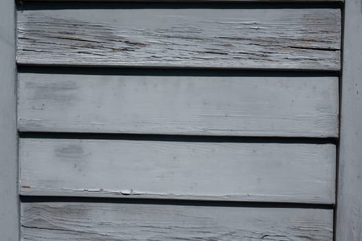 Light blue old wooden slats in the sunlight