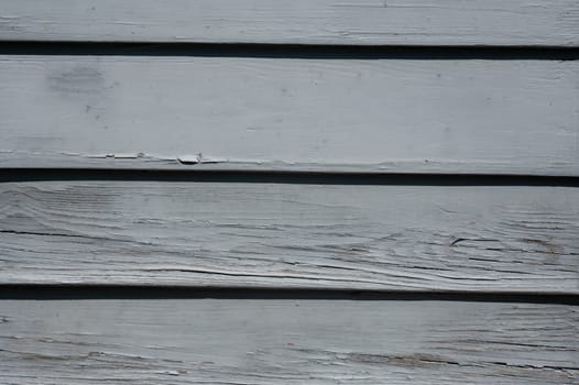 Light blue old wooden slats in the sunlight
