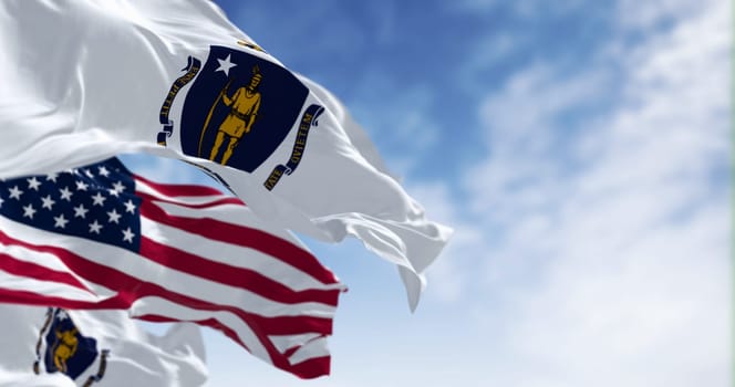 The flags of Massachusetts and the United States waving in the wind on a clear day. Patriotism and identity concept. 3d illustration render. Rippled fabric