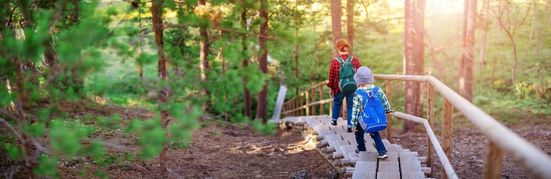 Mother ans son walking down on staircase in natural park. Concept of the family vacation and tourism.