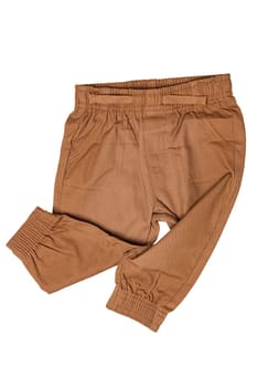 Clothes for newborn. Stylish brown baby pants or sweatpants isolated on white background.. Baby clothes. Kids trousers.