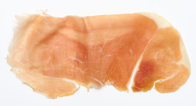 Thin piece of jamon on a white background, top view