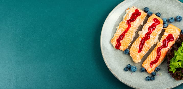 Fried salmon fillet with blueberry berry sauce. Healthy food. Space for text.