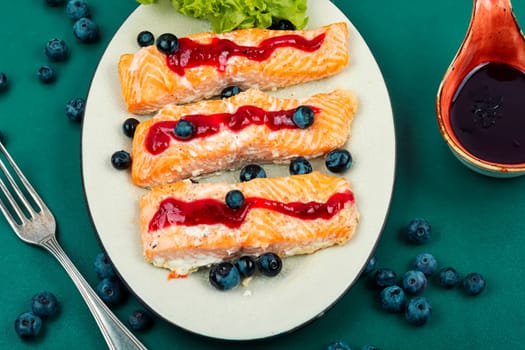 Fried salmon fillet with blueberry berry sauce. Healthy food. Space for text.